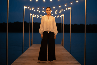 Pearl Flowy Long-Sleeve Ivory Top laid flat or shown on a model, highlighting its boho fabric and neckline in ivory