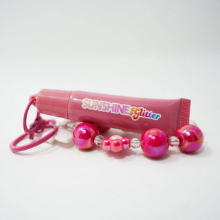 Rose Pink Lip Gloss Bag Charm shown up close to display its color and finish