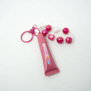 Rose Pink Lip Gloss Bag Charm shown up close to display its color and finish