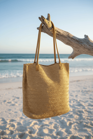 Straw Tote Bag shown from the front, highlighting its straw finish and hardware