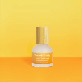 Tanned + Toasty Perfume Rollerball bottle displayed upright, showing its label and cap design