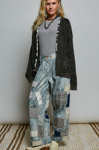 Woman smiling because she is wearing the Open-Front Cable Knit Cardigan, in Black with contrasting trim detail.  She is smiling because she just bought this super sweater at Beach GYpsy in Berlin, MD. Very happy indeed
