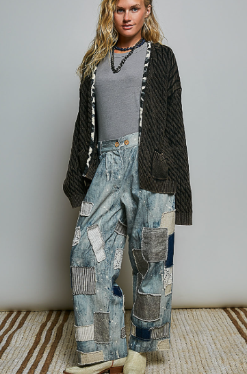 Woman smiling because she is wearing the Open-Front Cable Knit Cardigan, in Black with contrasting trim detail.  She is smiling because she just bought this super sweater at Beach GYpsy in Berlin, MD. Very happy indeed
