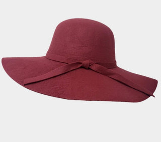 Burgundy felt floppy hat on white background 